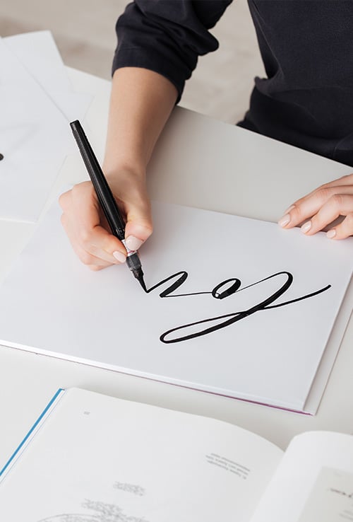 person writing calligraphy