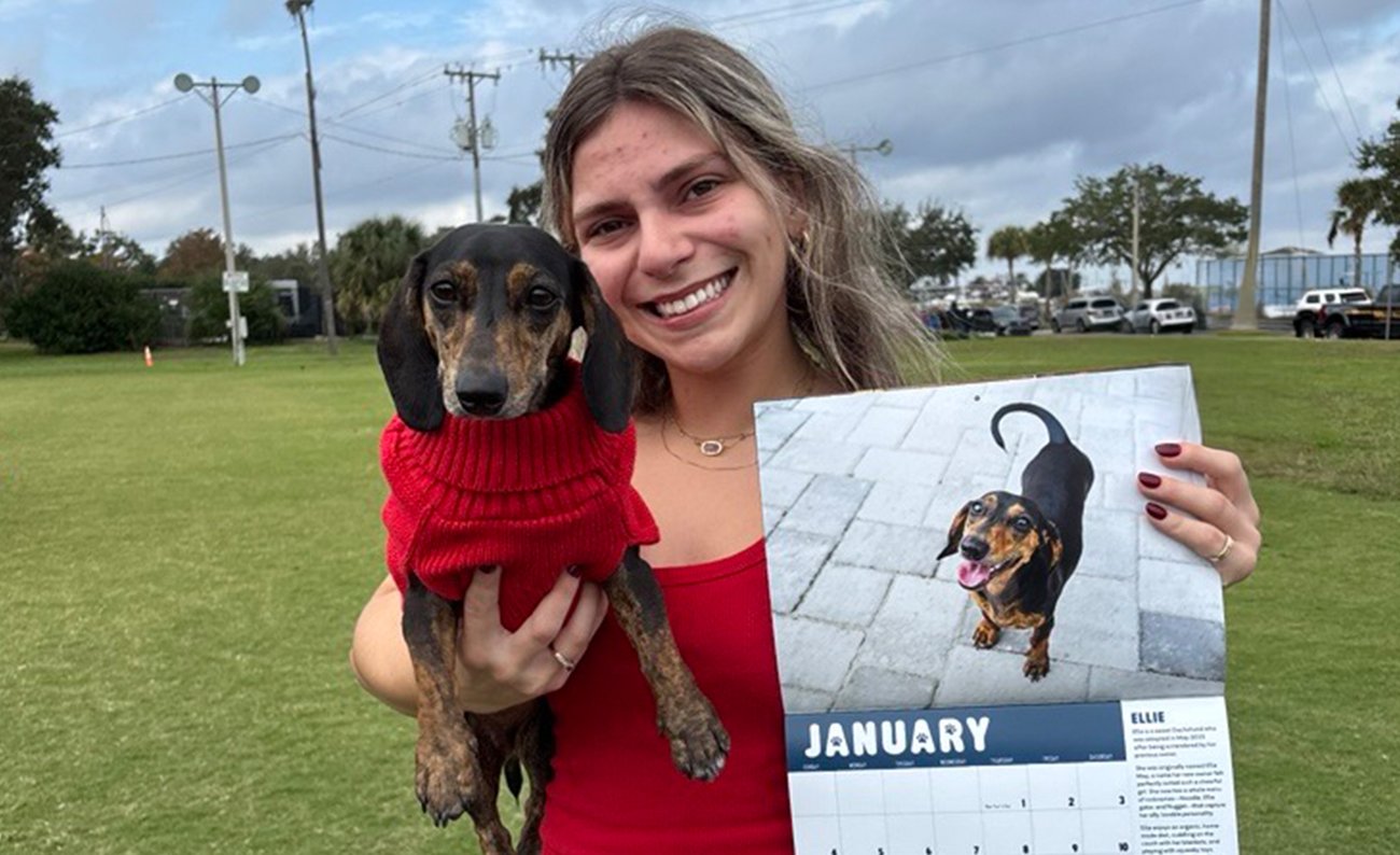 Girl holding Calendar with Dog Girl holding Calendar with Dog