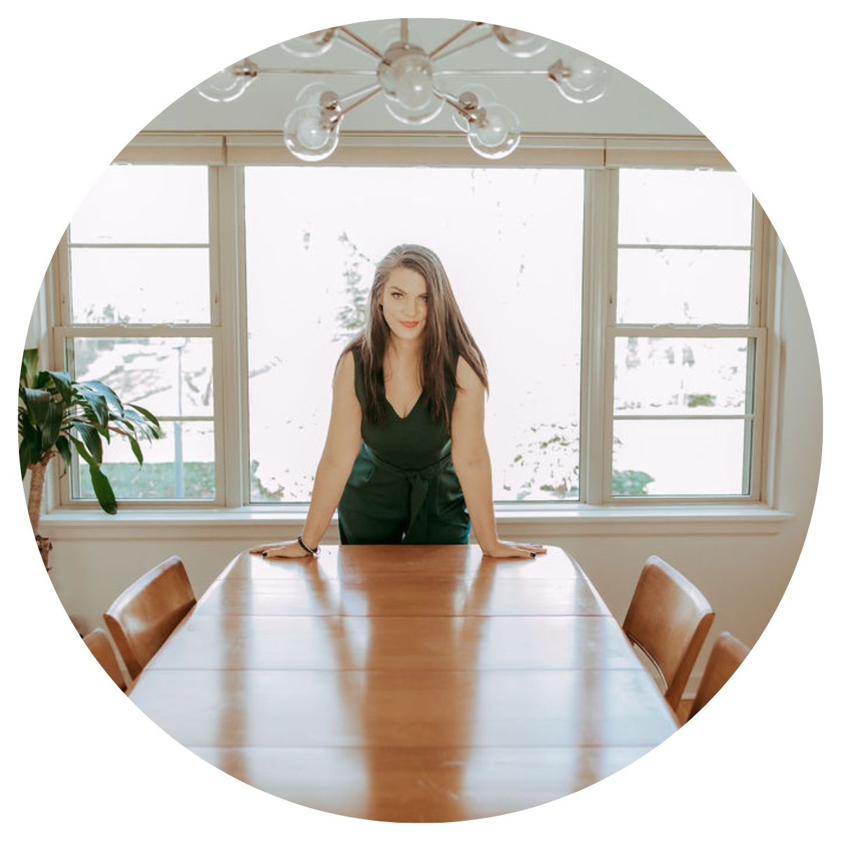 photo of Rachelle Siebke, Money coach at her desk, smiling hand on chin