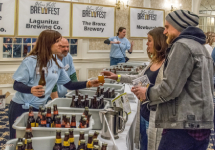 two people at a brewfest vendor table two people at a brewfest vendor table
