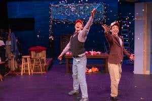 two actors on stage with confetti