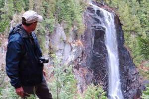 hiker by waterfall