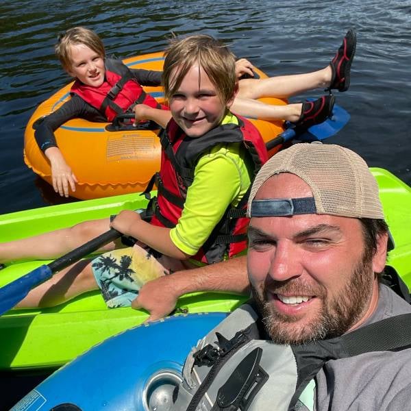 man with sons lazy river floating man with sons lazy river floating
