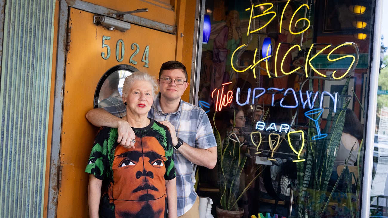 A woman and her son pose outside their bar, Big Chicks