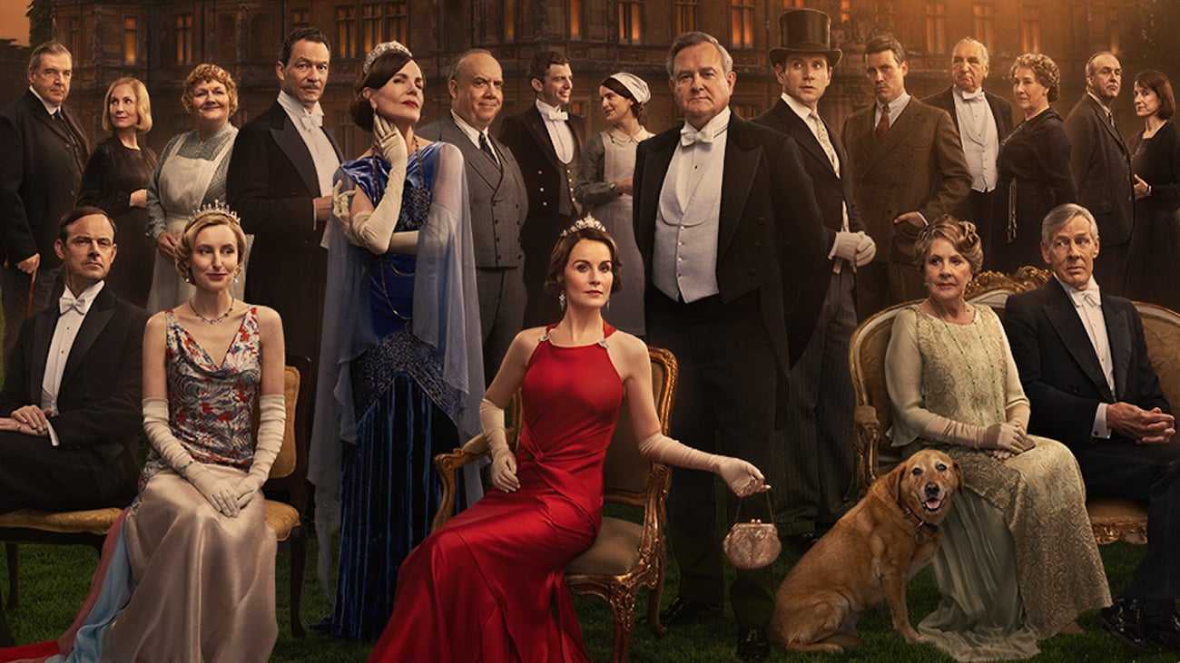 The cast of Downton Abbey: The Grand Finale arrayed in front of the house