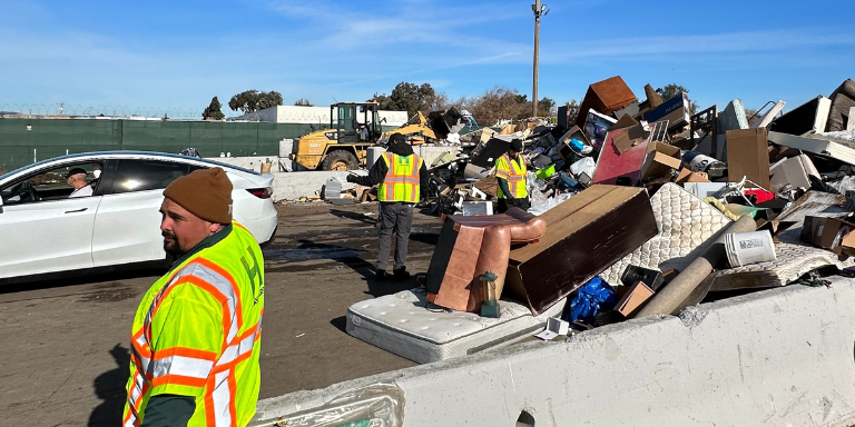 Photo of City workers assisting with the disposal of people's items. Photo of City workers assisting with the disposal of people's items.