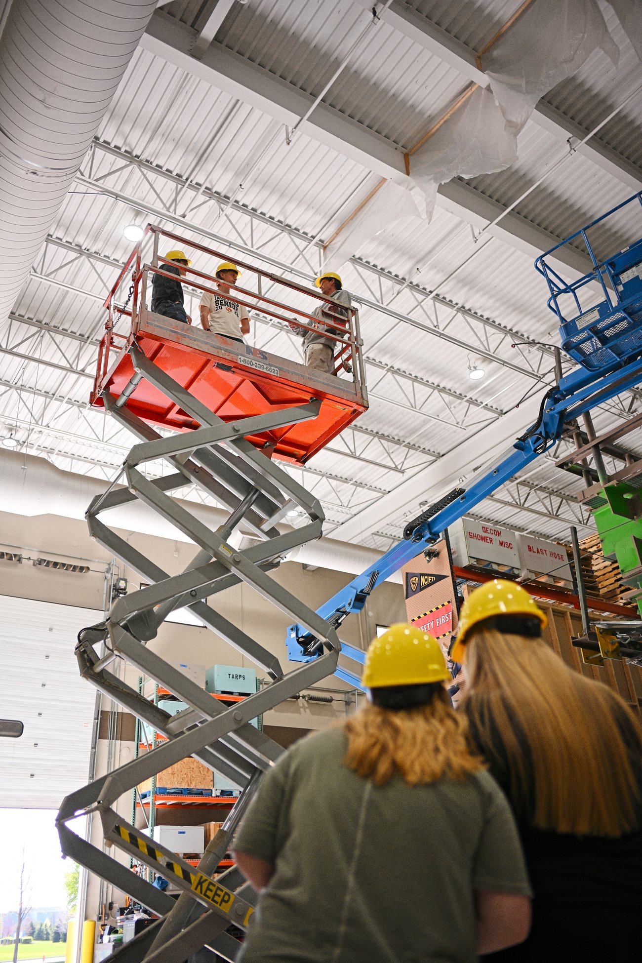 Apprenticeship Expo, people in hardhats chatting on an elevated platform