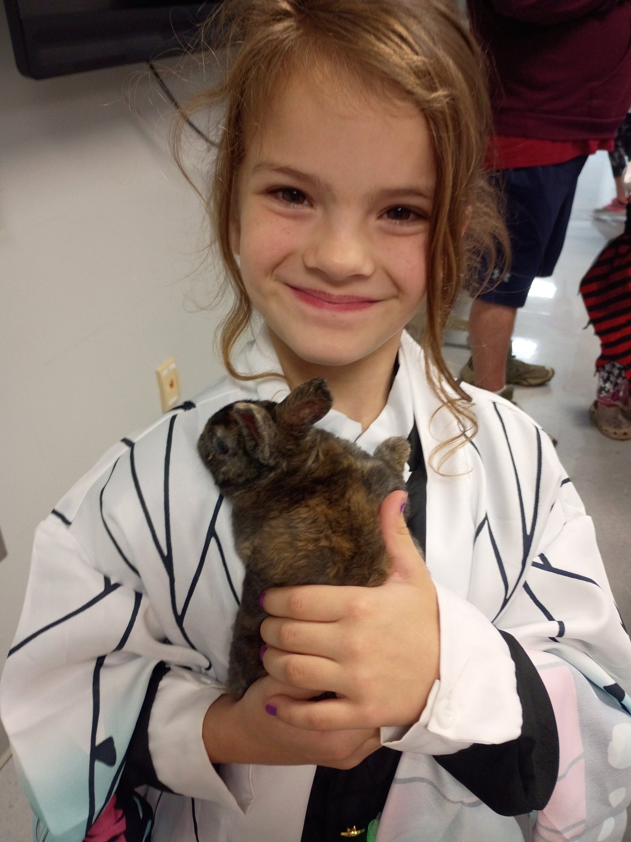 Child holding a brown bunny