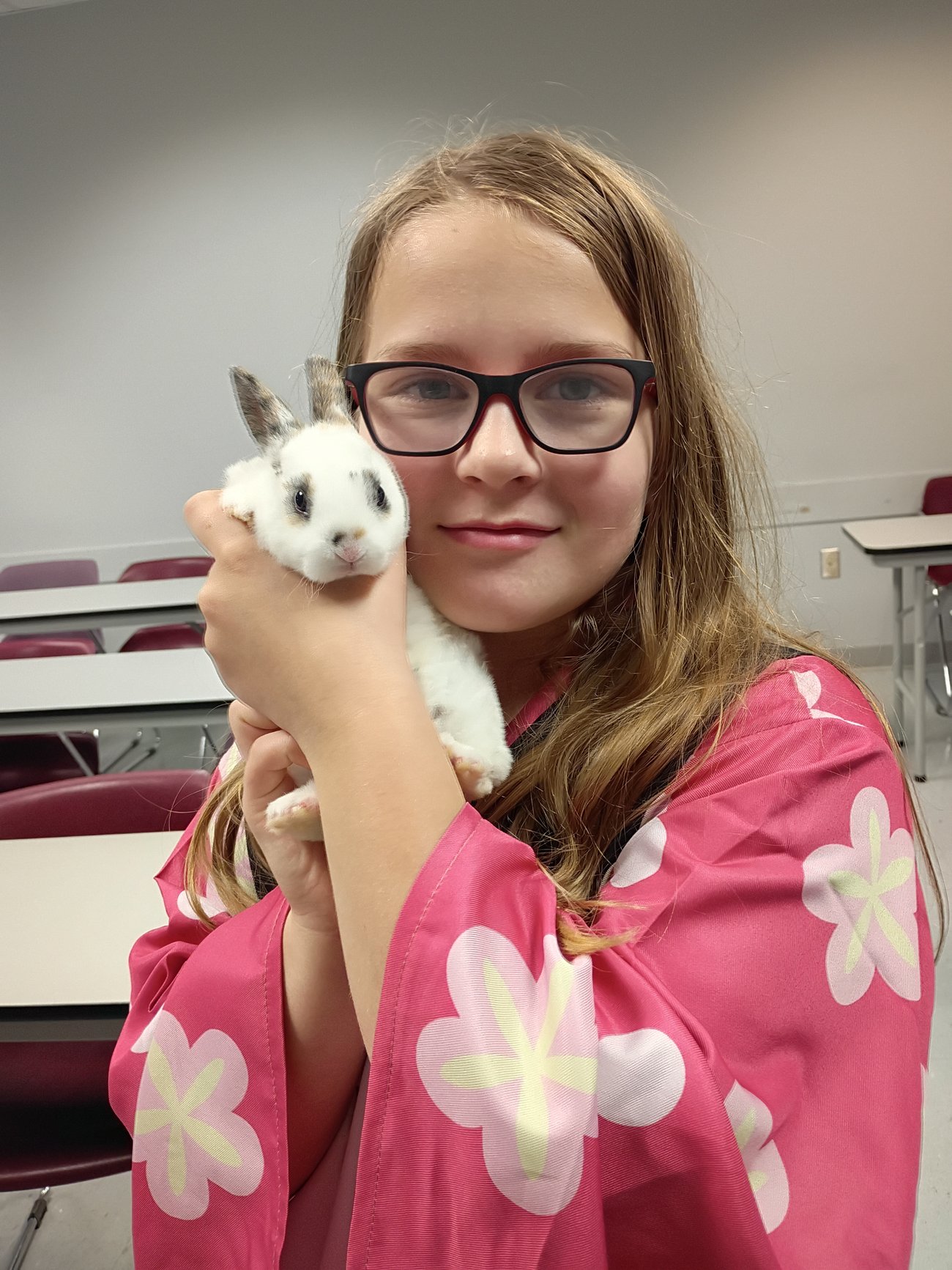 Child holding a white bunny