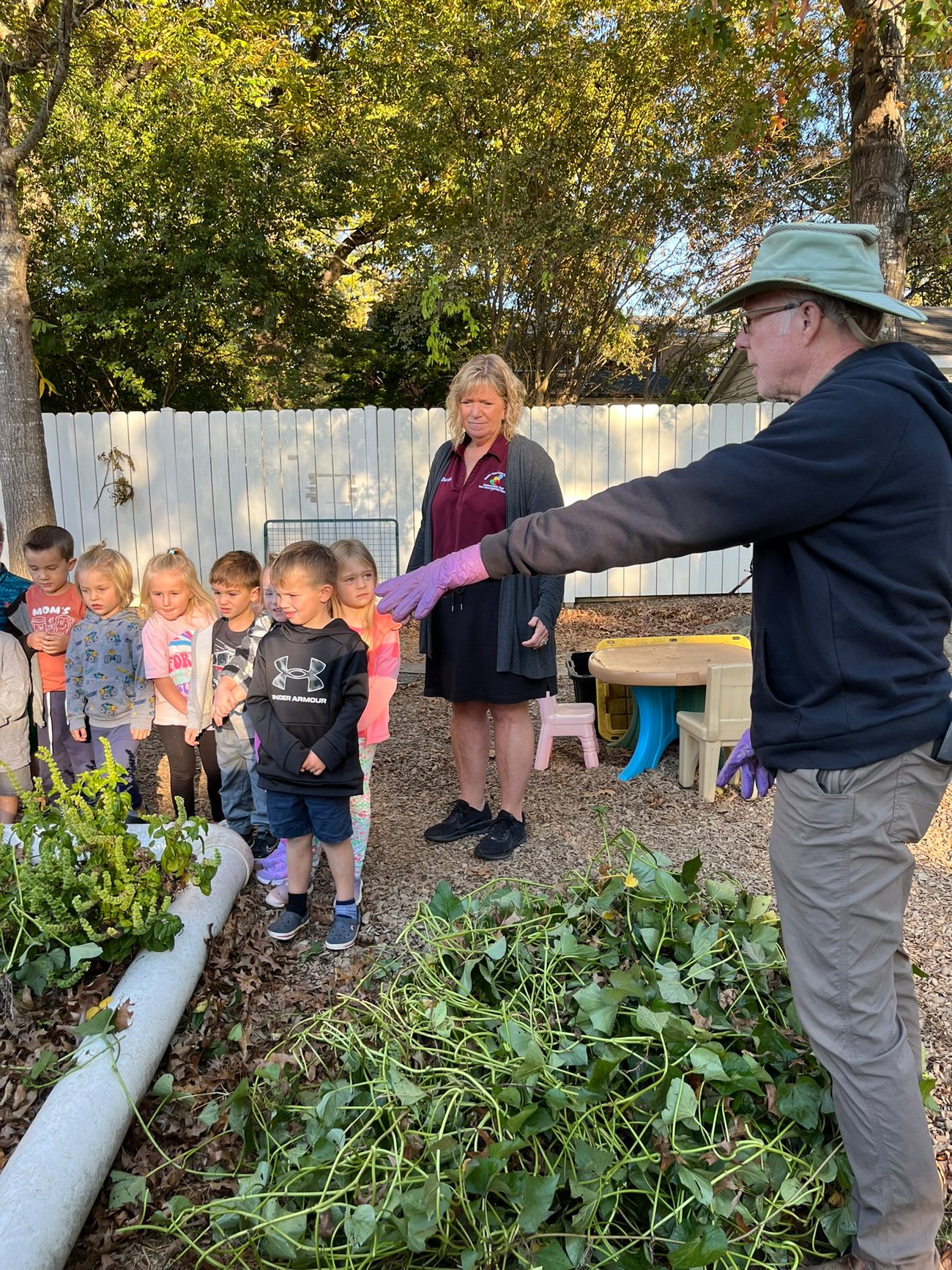 gardener teaching kids about sweet potatoes