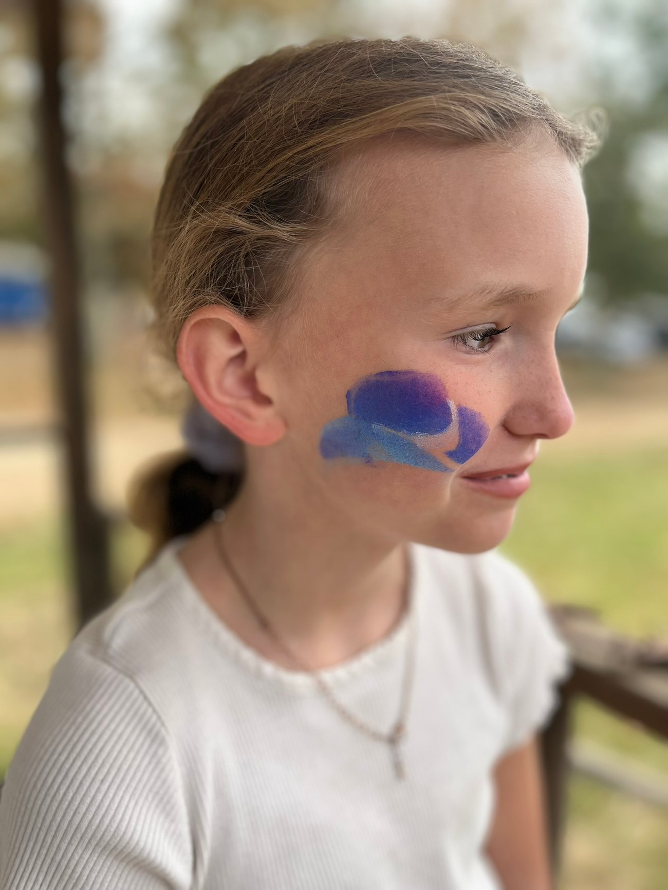 child with face paint at horse show