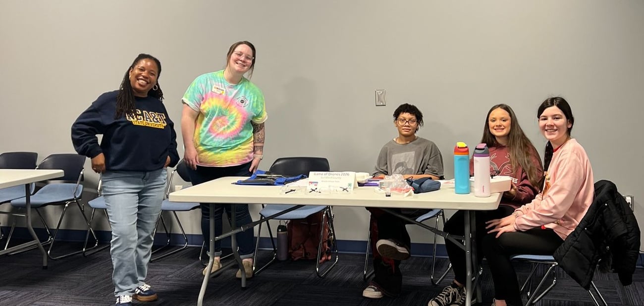 Photo from NC Cooperative Extension Guilford County Center Open House. People conversing and visiting information tables in the lobby. 