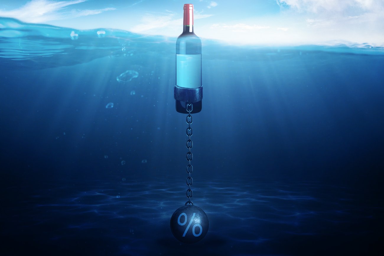 Photo illustration shows a bottle of wine sinking in water as it's pulled down by a weight with a "%" sign on it