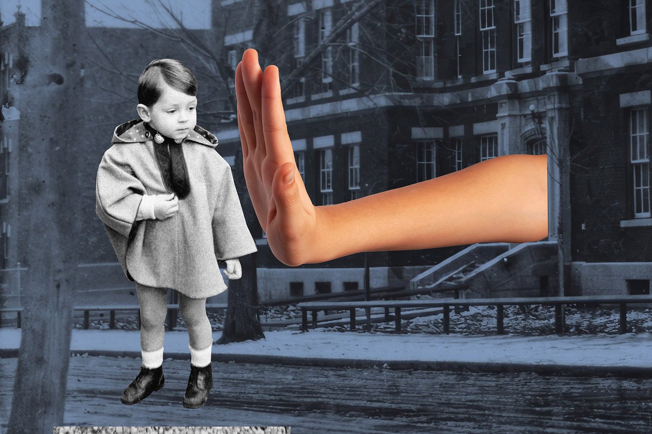 A black-and-white photo of a child outside of a school. An oversized hand is blocking them from the door