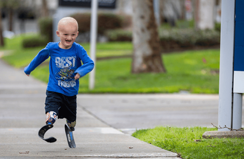 Image of Kamola Salimova, a person with long dark hour wairing a sweater. 