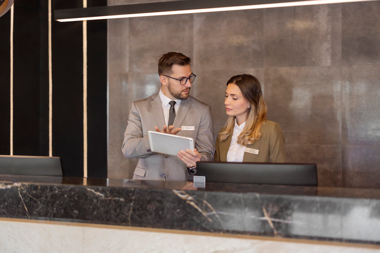 Hotel Receptionists Using Digital Tablet