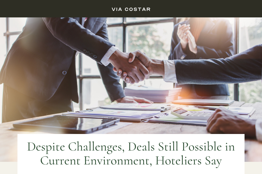 Via CoStar image: Two People shaking hands in a meeting. TEXT: "Despite Challenges, Deals Still Possible in Current Environment, Hoteliers Say."