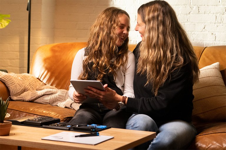 Image: A mother and daughter repair a tablet together