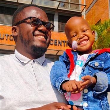 Image of a smiling father with his smiling daughter 