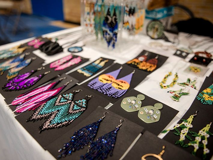 A table with Indigenous art and jewelry laid out. 