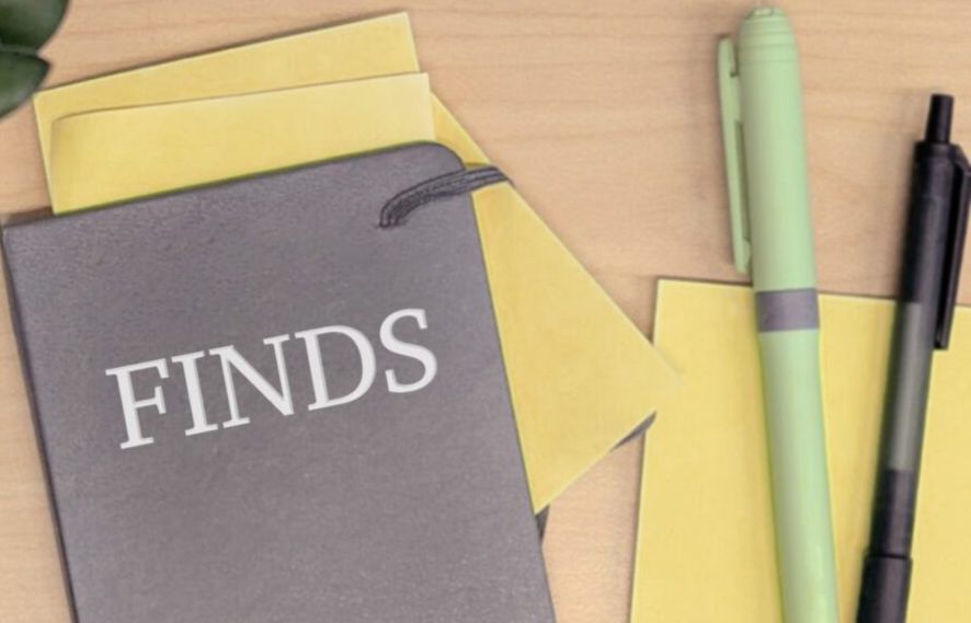 Notebook with sticky notes and pens on a wood desk The notebook is labeled "Finds" Notebook with sticky notes and pens on a wood desk The notebook is labeled "Finds"