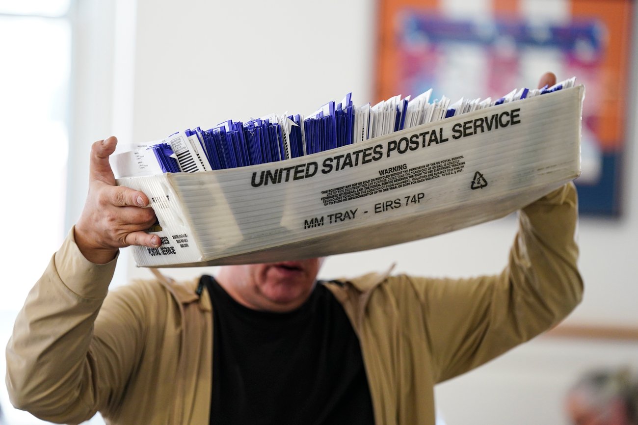 Workers sort mail ballots