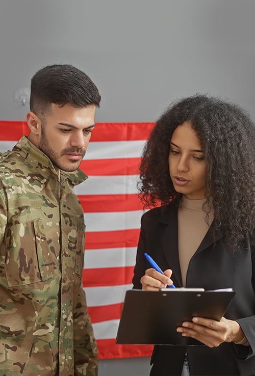 Veteran and attorney speaking pointing at paperwork