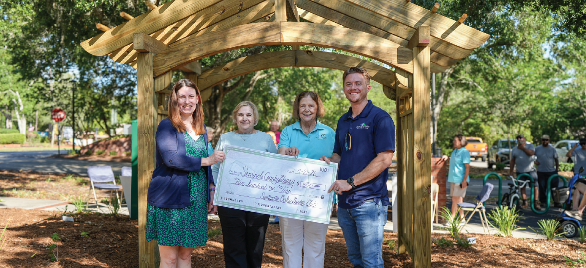 Members of the Sweetwater Oaks Garden Club and Seminole County staff gather beneath the newly constructed arbor at the West Branch Library garden sanctuary. Members of the Sweetwater Oaks Garden Club and Seminole County staff gather beneath the newly constructed arbor at the West Branch Library garden sanctuary.