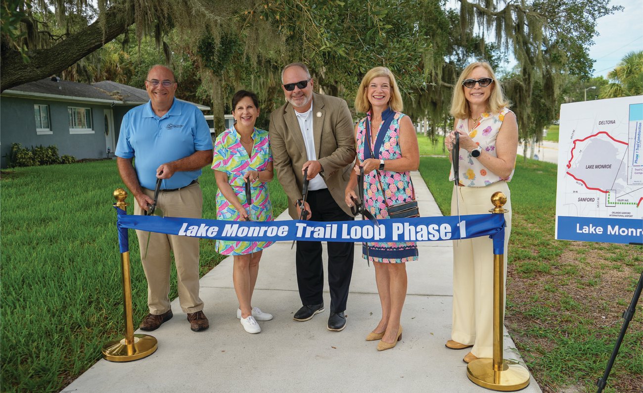 group of 5 leaders posing on trail at ribbon cutting ceremony group of 5 leaders posing on trail at ribbon cutting ceremony