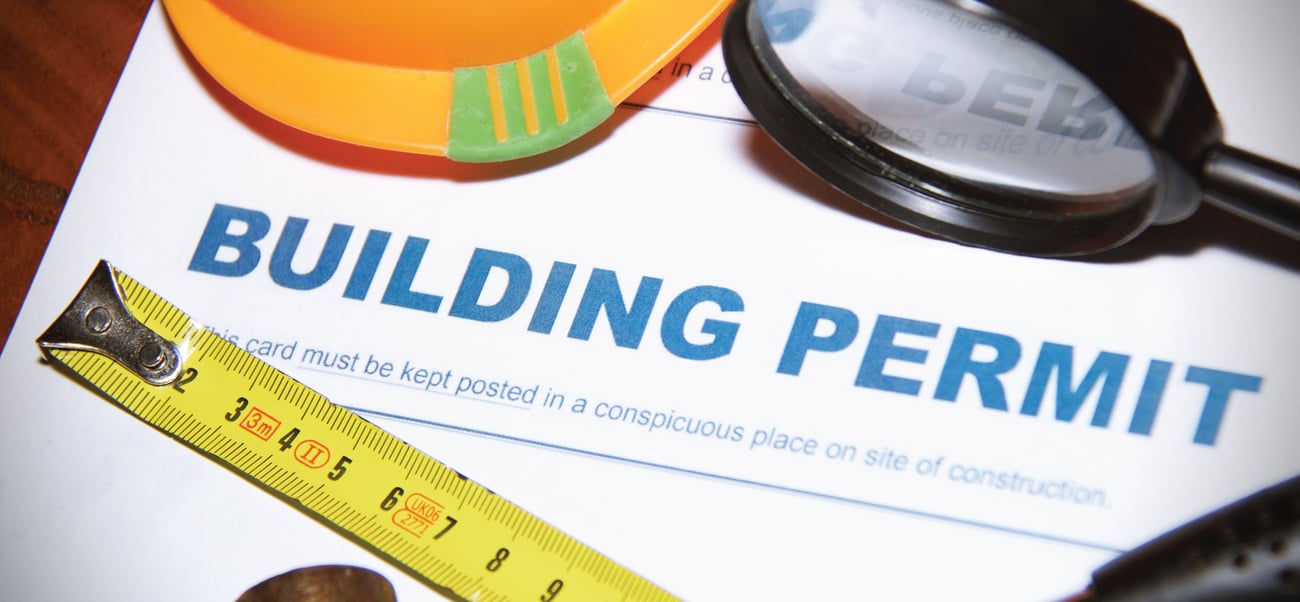 tape measure and paper saying building permit with hard hat and magnifying glass tape measure and paper saying building permit with hard hat and magnifying glass
