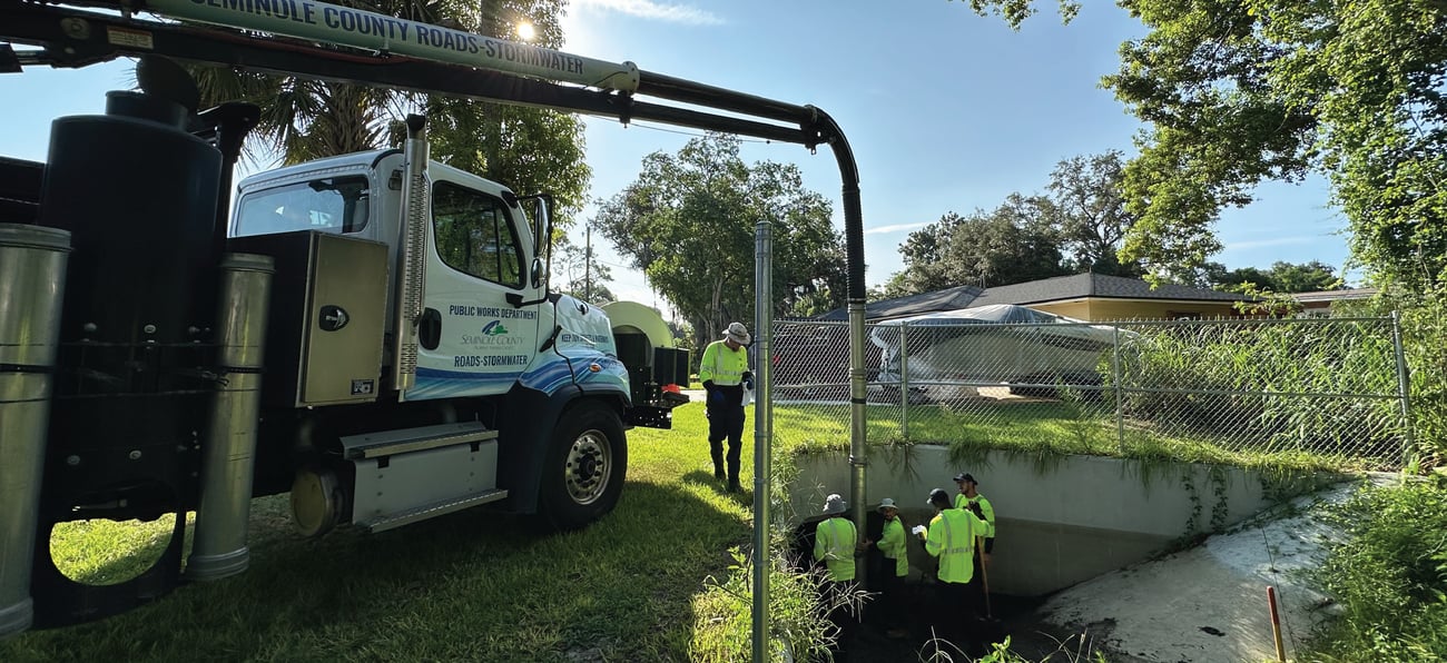 roads & stormwater truck on left with drainage equipment and crew on the right roads & stormwater truck on left with drainage equipment and crew on the right