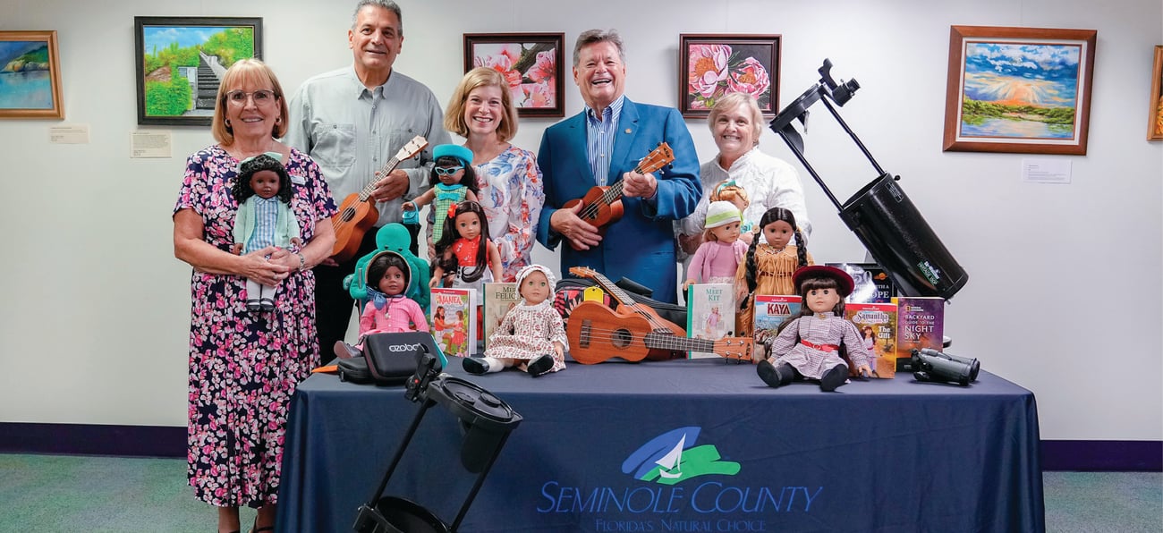 Seminole County Commissioners and Library Employees standing behind new collection of items to borrow Seminole County Commissioners and Library Employees standing behind new collection of items to borrow