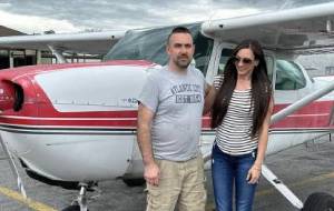 couple stands by helicopter