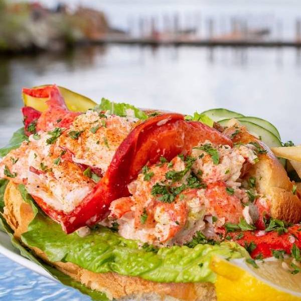 lobster roll with lake in background lobster roll with lake in background