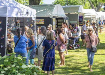 people walking around an outdoor craft fair