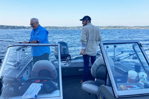 two fishermen on a motor boat