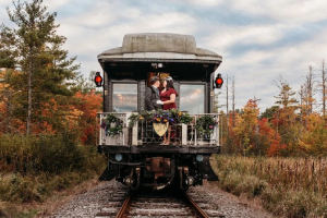 man and woman kissing on a train during fall