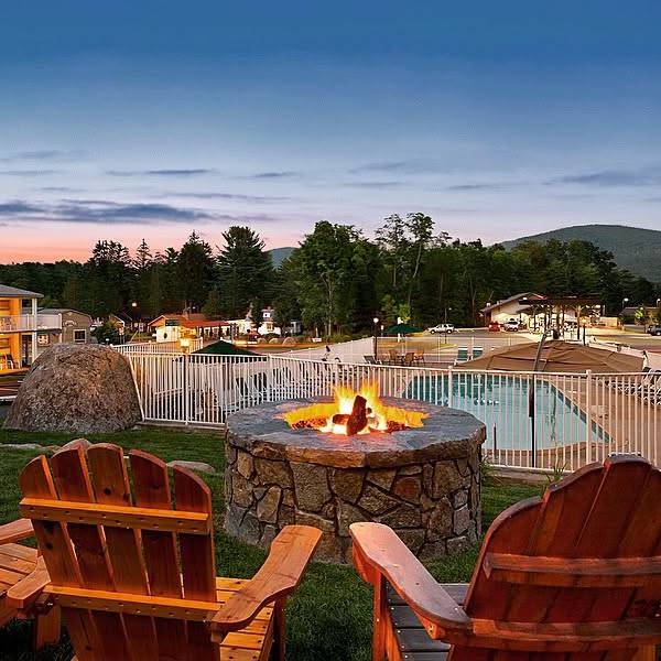 adirondack chairs by fire pit by pool