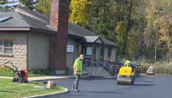 people paving a driveway