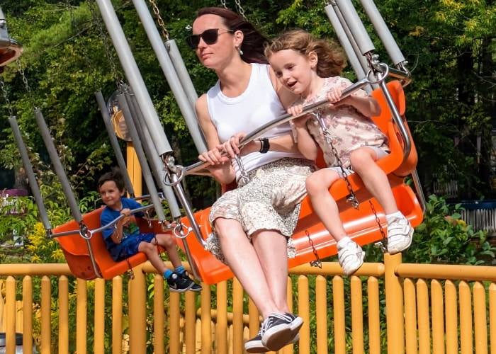mom and kid on swing ride