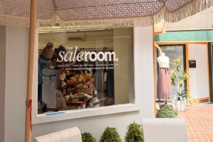 window with logo for the sale room store