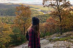 woman at mountain summit in fall