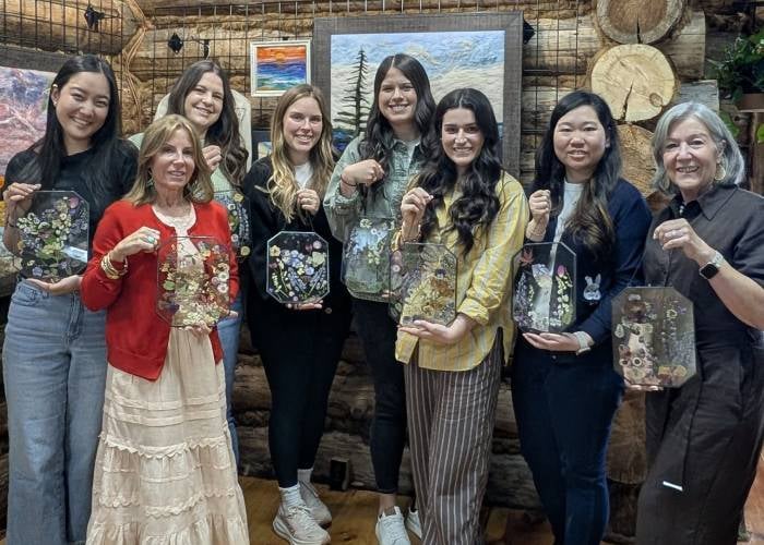 women holding up craft project
