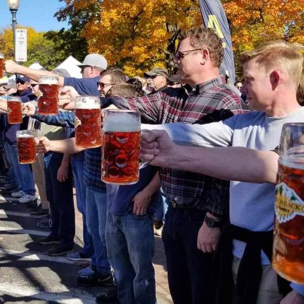 men holding beer steins