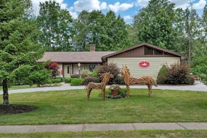 exterior of house with horse statues of sticks