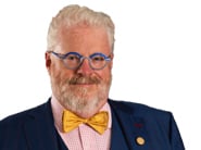Image of a university president wearing glasses, a suit and a bow tie