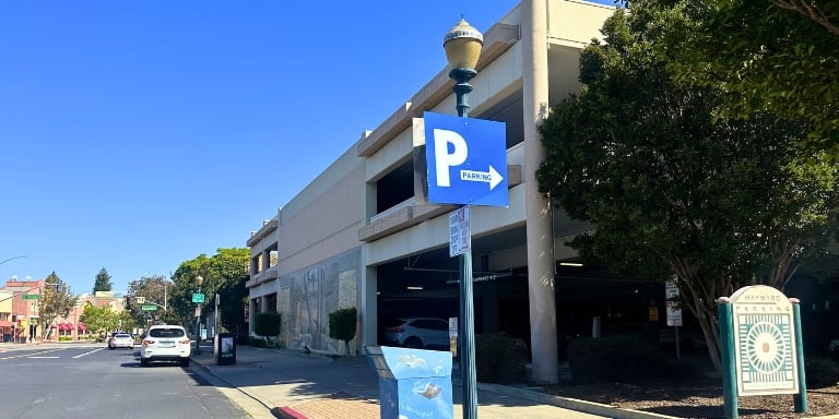 Blue sign with a white letter "P" indicating parking nearby Blue sign with a white letter "P" indicating parking nearby