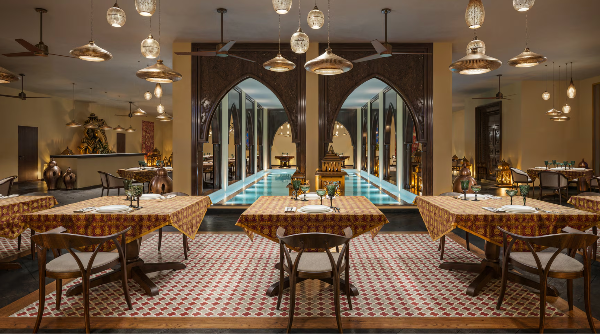 An ornate dining room with patterned tables, pendant lights, and a central indoor pool An ornate dining room with patterned tables, pendant lights, and a central indoor pool