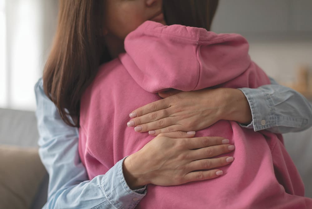 Woman hugging a child