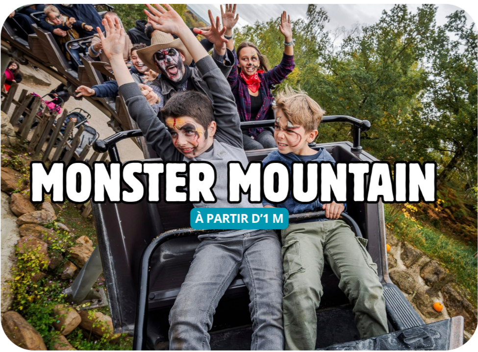 People with face paint raise their hands while riding a mountain coaster